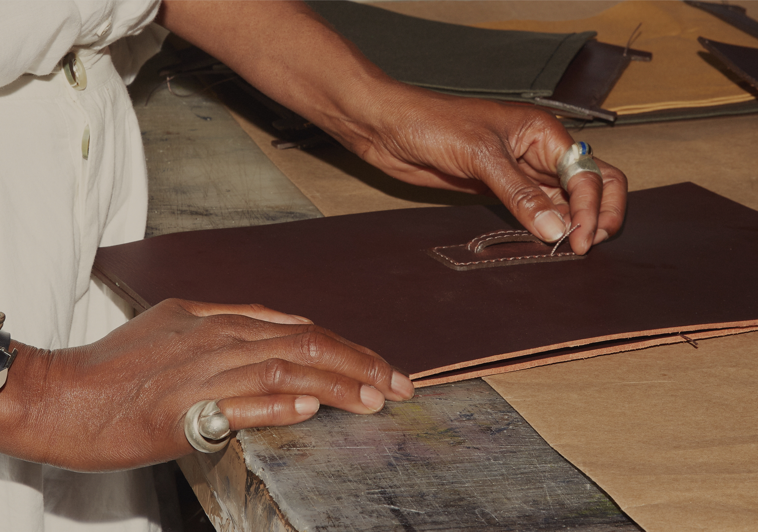 Person working with leather at a studio
